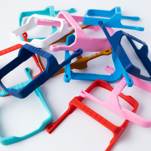 A collection of 3D printed Cradle handheld carriers in various colors, including B-stock and V1 clearance units.