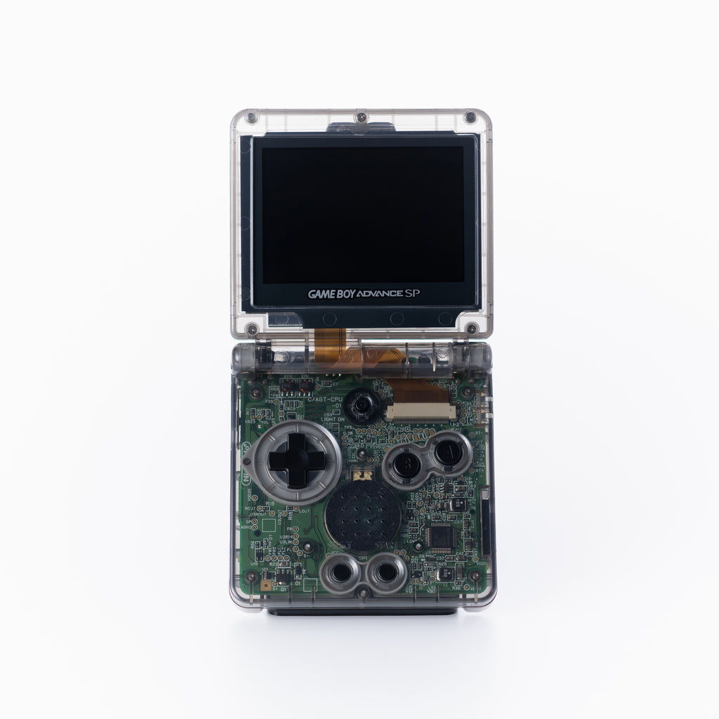 A custom Game Boy Advance SP handheld game console with a transparent shell, showing the green printed circuit board (PCB) underneath on an off white background.