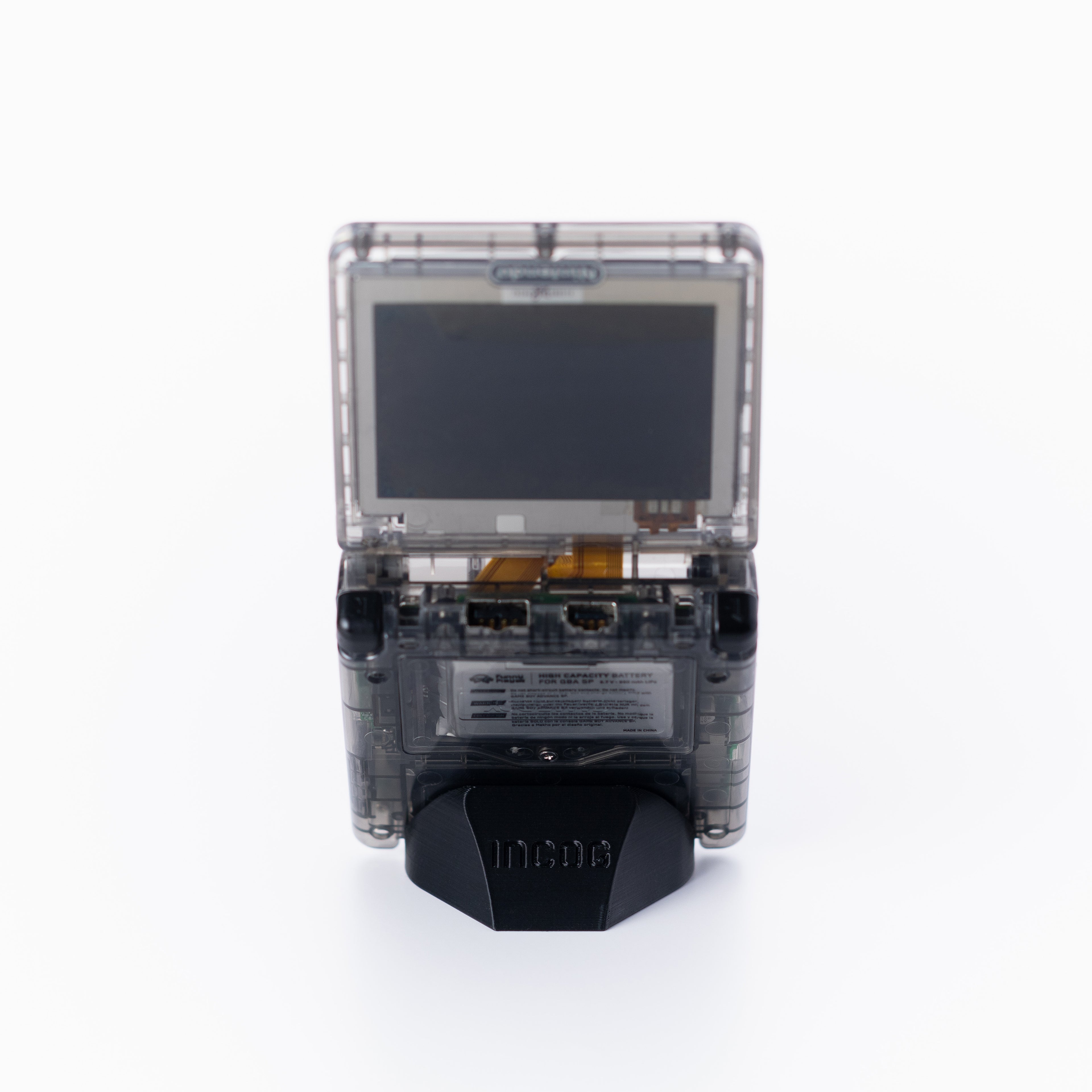 A translucent black game boy advance sp console, using an INCOG display stand shown from the back on an off white background.