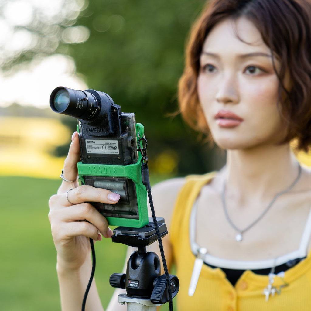 Back view of a woman using a 3D-printed Game Boy Pocket mount to take a photo.